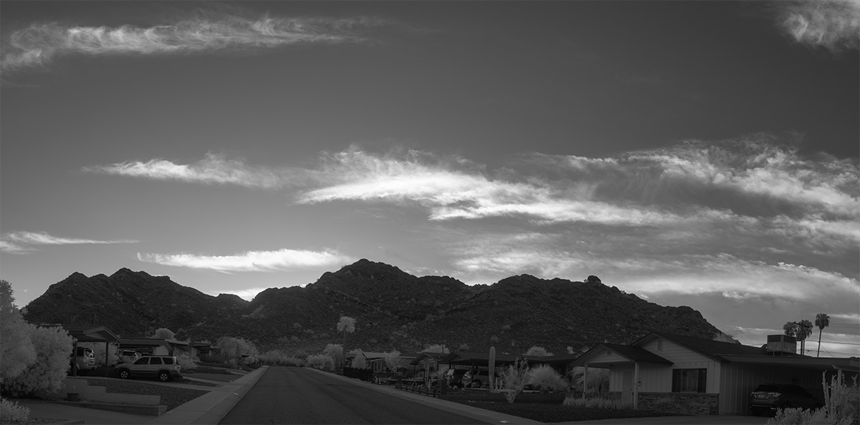 Infrared Photographic Panorama of Backlit Desert Hill and Suburban Street.